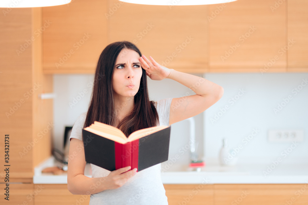 Pensive Woman Reading a Book in The Kitchen Pensive Woman Reading a Book in The Kitchen