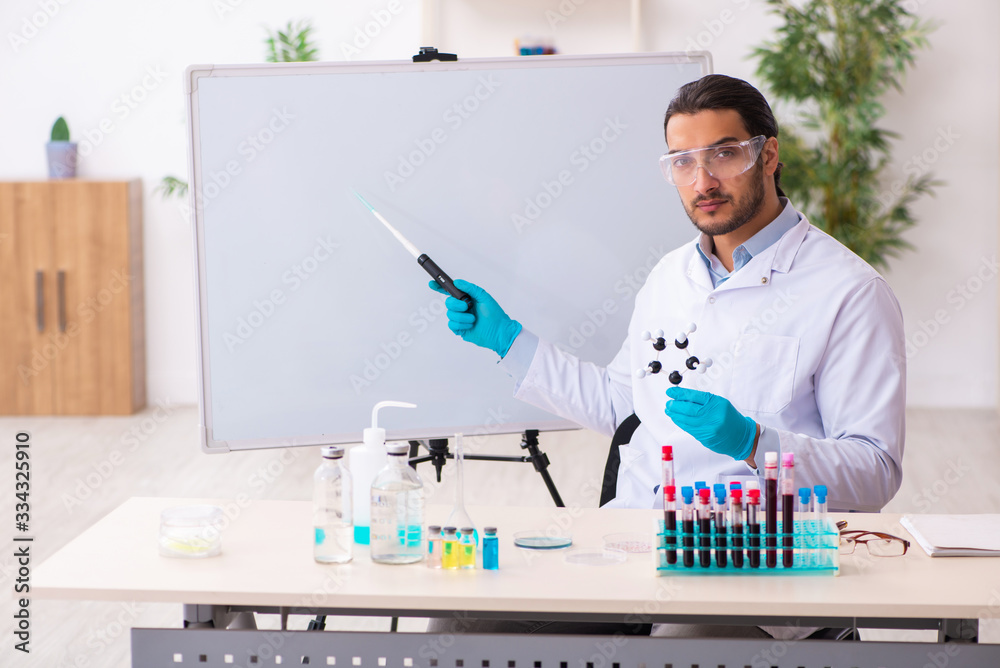 Young male chemist working in the lab Young male chemist working in the lab
