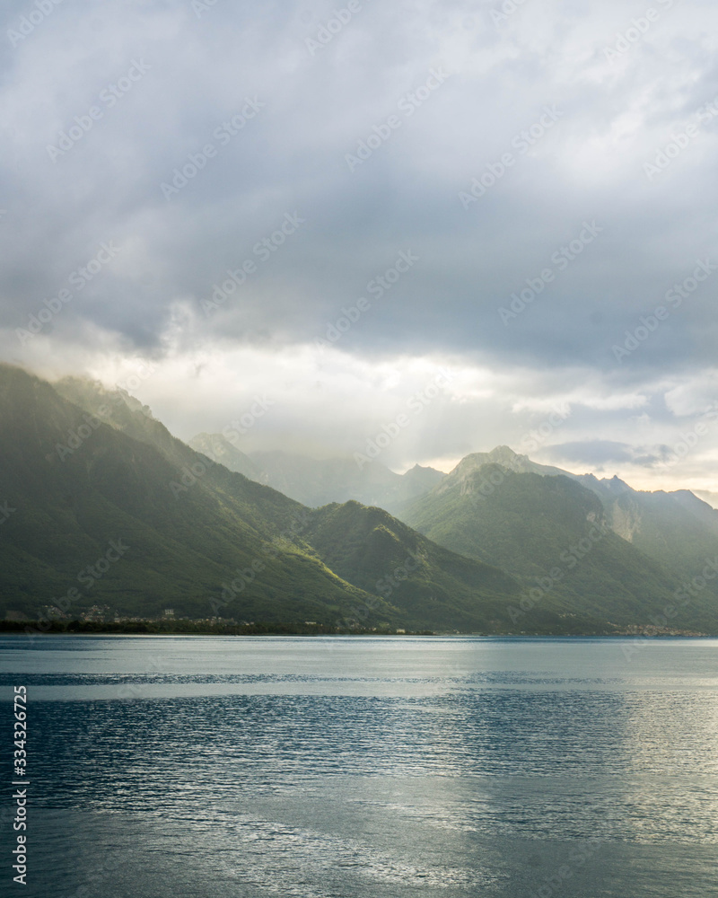 Sun beams hitting the French Alps after a storm on Lake Geneva