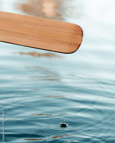 Water drop falling off canoe paddle