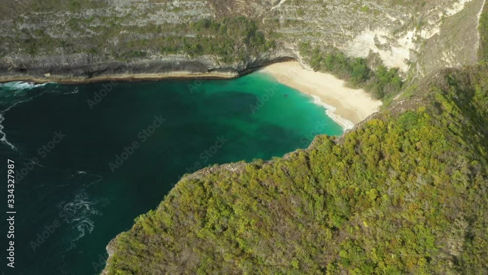 View from above, stunning aerial view of a T-Rex shaped cliffs with the beautiful Kelingking Beach bathed by a turquoise sea. Nusa Penida, Indonesia. View from above, stunning aerial view of a T-Rex shaped cliffs with the beautiful Kelingking Beach bathed by a turquoise sea. Nusa Penida, Indonesia.