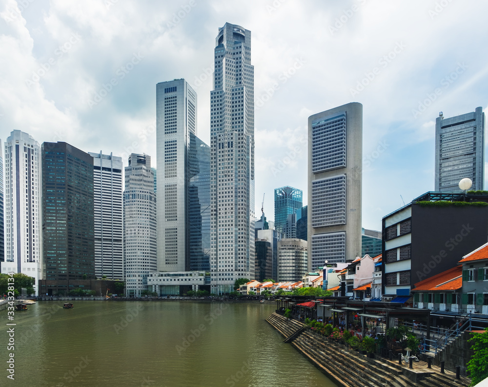 Modern skyline of Singapore city, urban asian cityscape with skyscraper buildings and river with boat in commercial business district