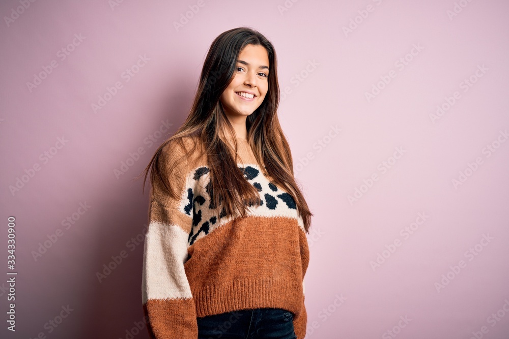 Young beautiful woman wearing fashion urban clothes, model wearing casual street style standing over pink background Young beautiful woman wearing fashion urban clothes, model wearing casual street style standing over pink background