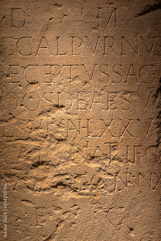 Brown stone wall with Roman writing. Brown stone wall with Roman writing.