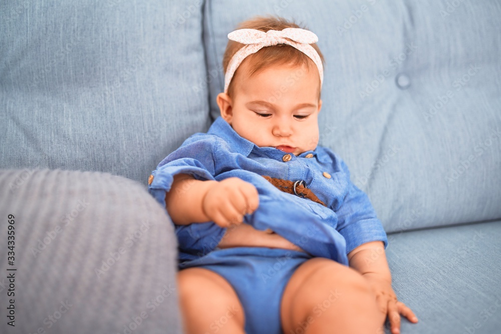 Adorable baby lying down on the sofa at home. Newborn relaxing and resting comfortable Adorable baby lying down on the sofa at home. Newborn relaxing and resting comfortable