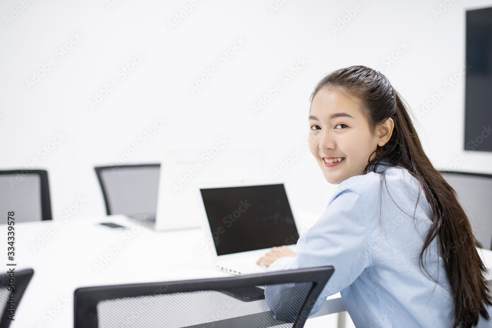 Asian success businesswoman happy using laptop computer connect internet working from home in white room with copy space