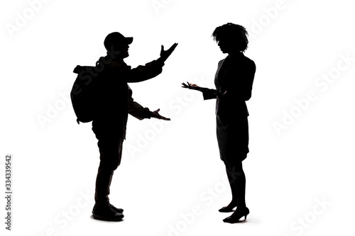 Silhouette of people talking to each other, socializing and not practicing social distancing.  They are on a white background and meeting or sharing gossip
