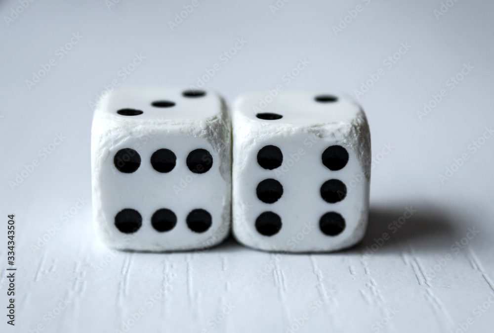 Macro photograhpy to an Old white dices with double six pair over a white table Macro photograhpy to an Old white dices with double six pair over a white table