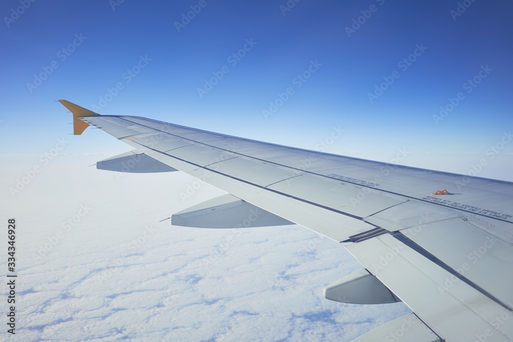 Cloudscape from window airplane, landscape of wing plane on a cloudy sky Cloudscape from window airplane, landscape of wing plane on a cloudy sky