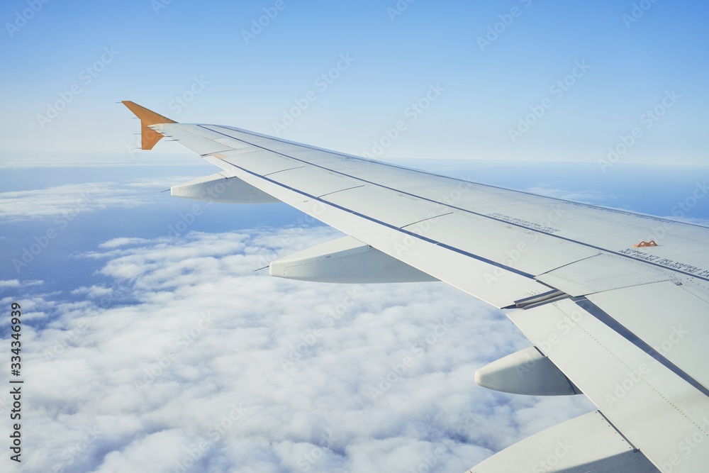 Obraz premium Cloudscape from window airplane, landscape of wing plane on a cloudy sky