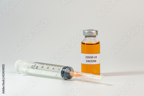 COVID-19 vaccine concept with white background and syringe injection