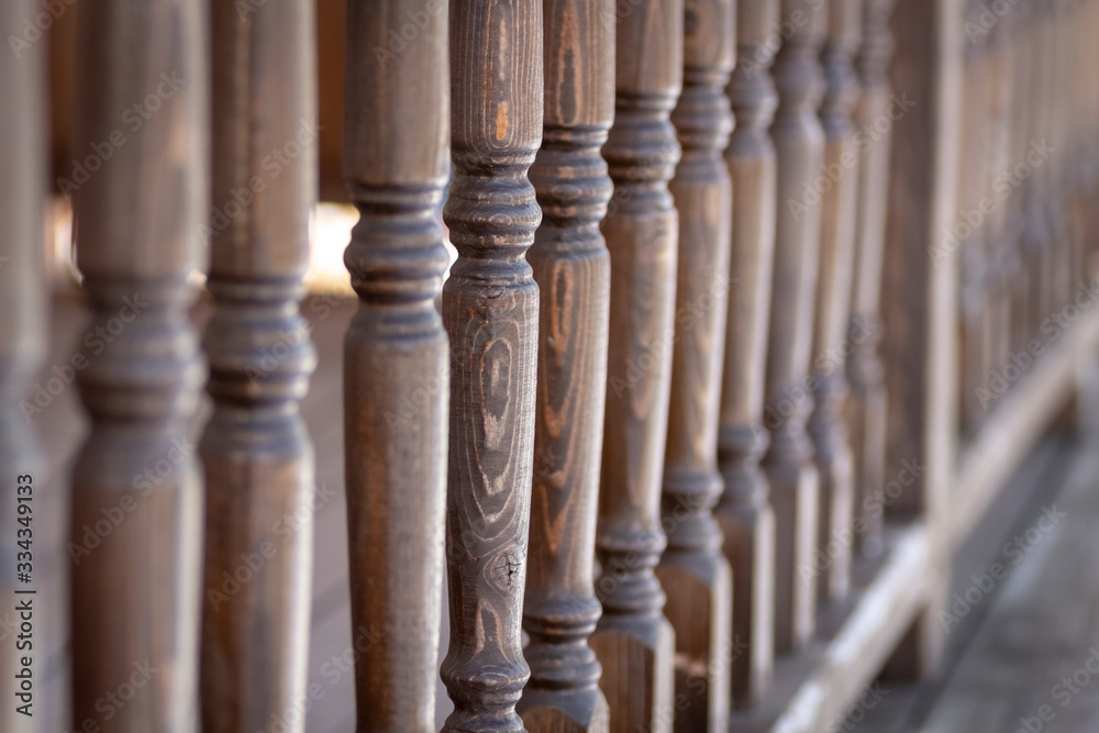 A row of balusters of a wooden veranda. A row of balusters of a wooden veranda.