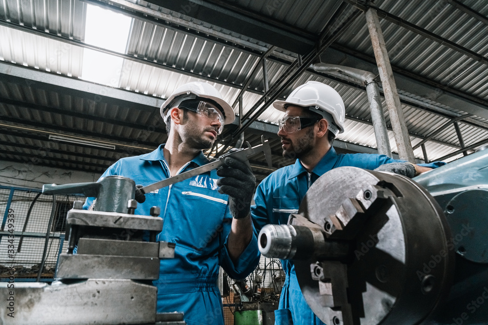 custom made wallpaper toronto digitalEngineer men wearing uniform safety in factory working machine lathe metal.
