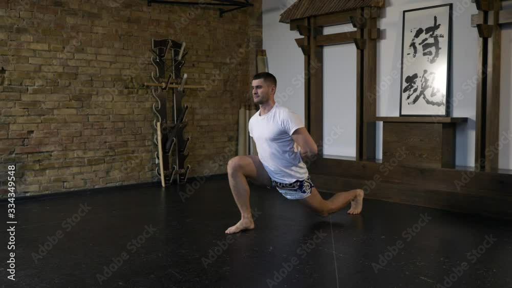 Martial Arts Fighter Sportsman Warming up. Man Performing Exercises. Preparing For Training Fight. Athlete Stretching Workout in Studio. Eastern Asian Style. 2x Slow motion - 0.5 speed 60 FPS Martial Arts Fighter Sportsman Warming up. Man Performing Exercises. Preparing For Training Fight. Athlete Stretching Workout in Studio. Eastern Asian Style. 2x Slow motion - 0.5 speed 60 FPS