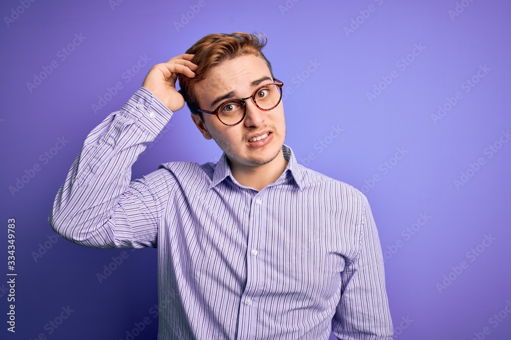 Young handsome redhead man wearing casual shirt and glasses over purple background confuse and wonder about question. Uncertain with doubt, thinking with hand on head. Pensive concept. Young handsome redhead man wearing casual shirt and glasses over purple background confuse and wonder about question. Uncertain with doubt, thinking with hand on head. Pensive concept.