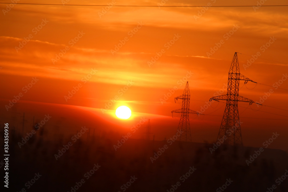 high voltage poles at dawn