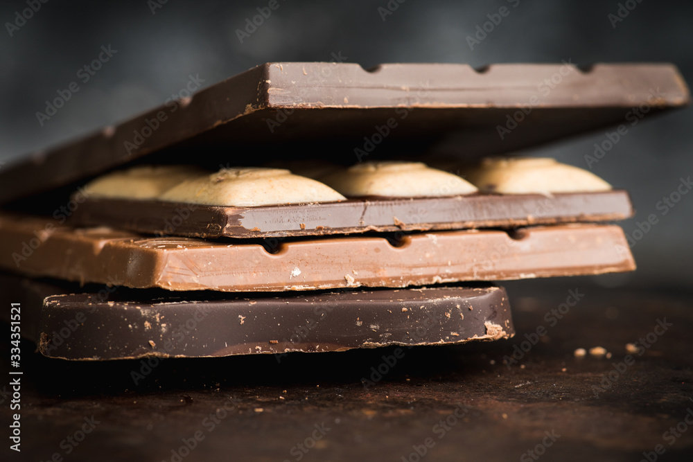 Chocolate bar on the rustic background. Selective focus. Shallow depth of field. Chocolate bar on the rustic background. Selective focus. Shallow depth of field.
