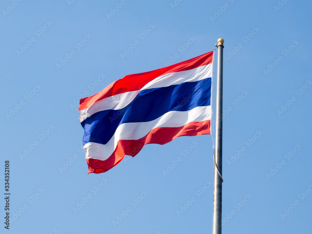 Thai flag on a blue sky background.