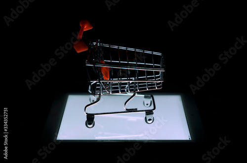 Online shopping concept, small shopping cart on the Tablet