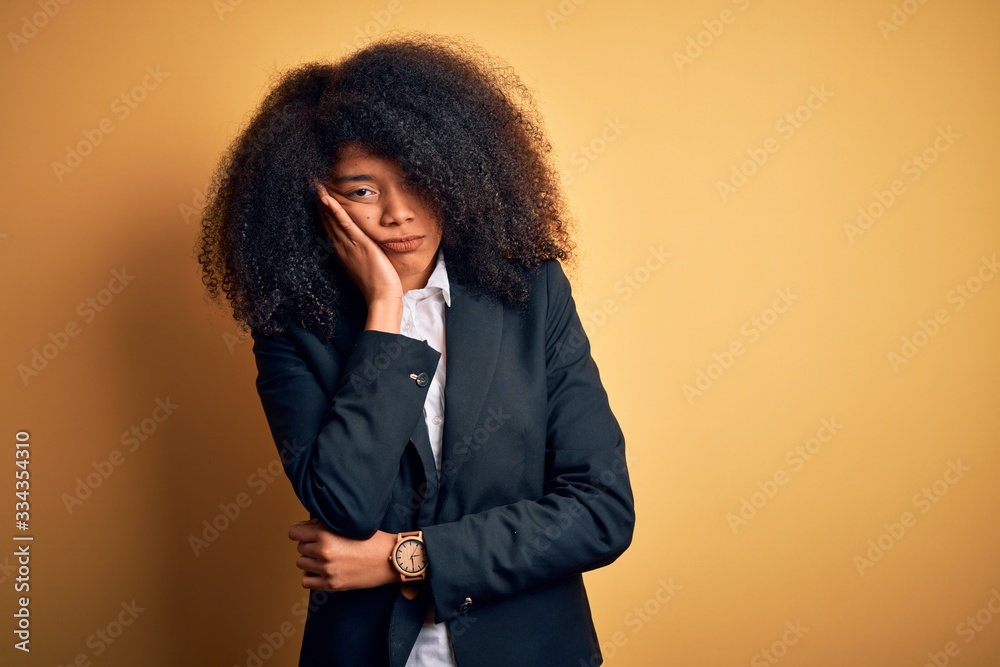 Young beautiful african american business woman with afro hair wearing elegant jacket thinking looking tired and bored with depression problems with crossed arms. Young beautiful african american business woman with afro hair wearing elegant jacket thinking looking tired and bored with depression problems with crossed arms.