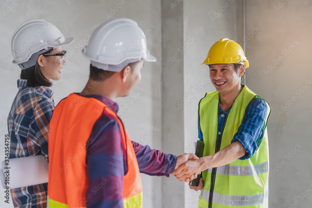 construction worker and contractor. Client shaking hands with team builder in renovation site. construction worker and contractor. Client shaking hands with team builder in renovation site.