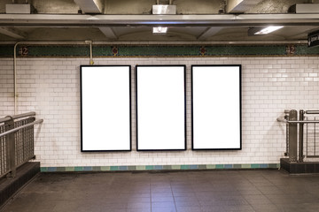 advertisement billboards electronic displays in a subway station in New York City
