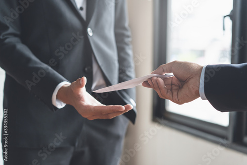 Close up view of  office worker receiving salary from boss.