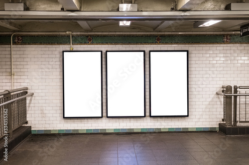 advertisement billboards electronic displays in a subway station in New York City