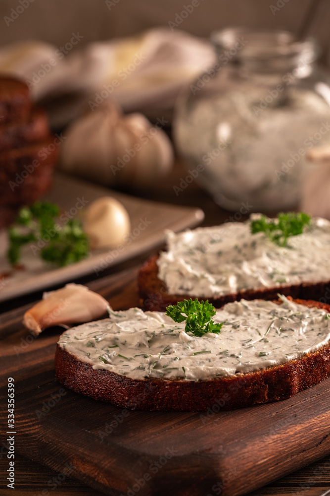Black bread croutons with garlic and herbs with sauce on a wooden table Black bread croutons with garlic and herbs with sauce on a wooden table