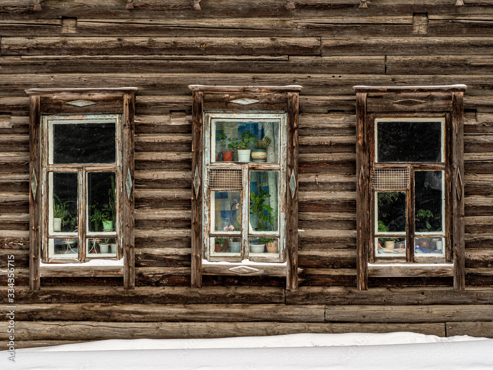 Three windows of a wooden house