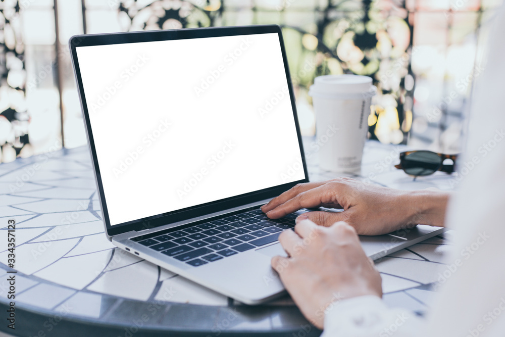 computer mockup image blank screen with white background for advertising text,hand woman using laptop contact business search information on desk at coffee shop.marketing and creative design computer mockup image blank screen with white background for advertising text,hand woman using laptop contact business search information on desk at coffee shop.marketing and creative design