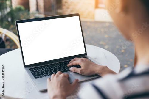 computer mockup image blank screen with white background for advertising text,hand woman using laptop contact business search information on desk at coffee shop.marketing and creative design