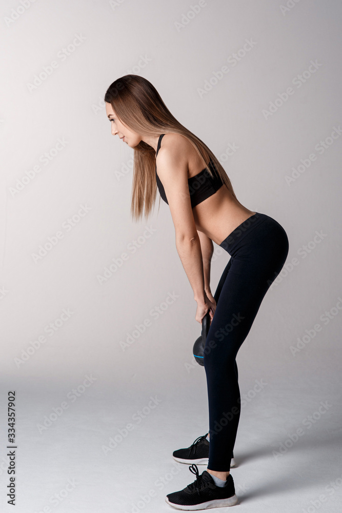 Athletic woman with kettlebell doing a lunges. Photo of latin woman in silhouette isolated on white background. Strength and motivation. Side view Athletic woman with kettlebell doing a lunges. Photo of latin woman in silhouette isolated on white background. Strength and motivation. Side view