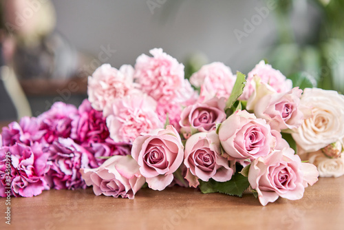 Floral shop concept . Blank for flower arrangement in a wicker basket. Beautiful bouquet of mixed flowers. Handsome fresh bunch. Flowers delivery.