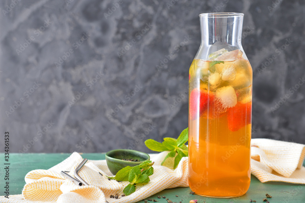 Jug of tasty cold tea on table Jug of tasty cold tea on table