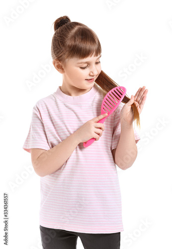 Little girl brushing hair o...