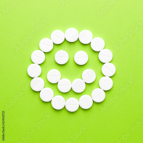 Happy face made of pills on...