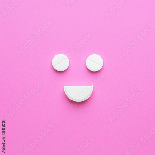 Happy face made of pills on...