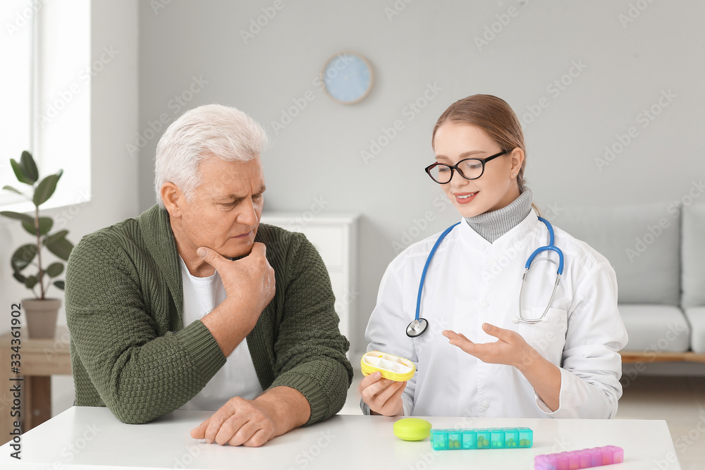 Doctor giving pills to patient in clinic Doctor giving pills to patient in clinic