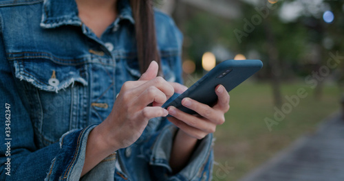 Woman wear blue jeans and use of smart phone at outdoor