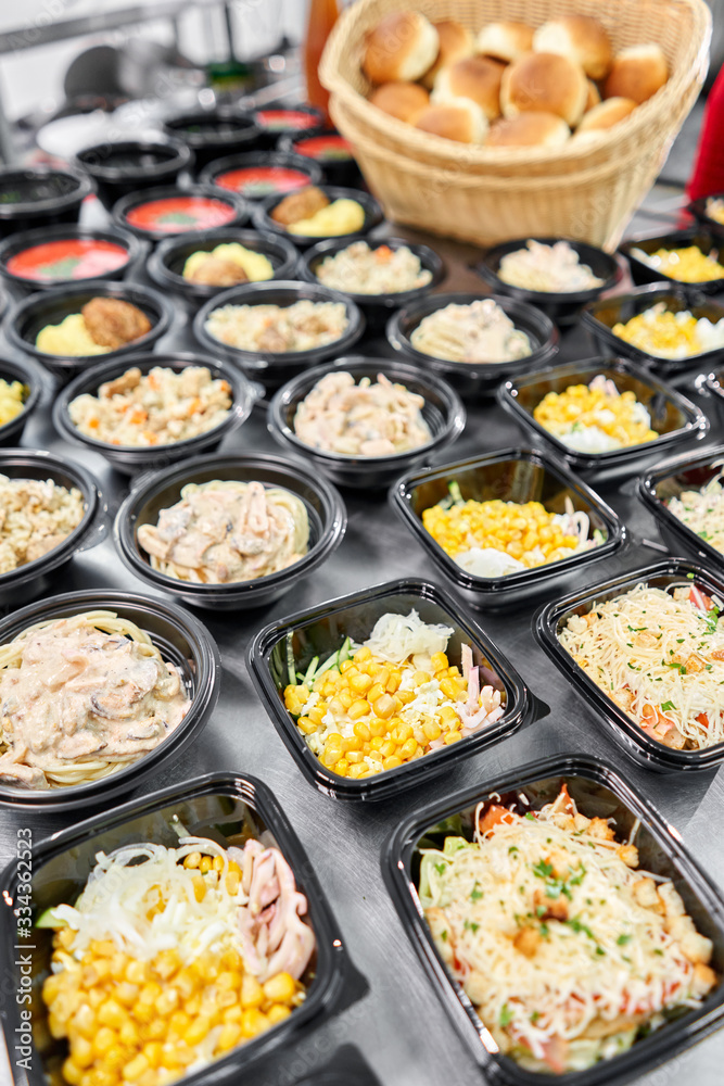 Food delivery. Different in plastic disposable lunch box with healthy natural food. Chicken broth, mashed soup, mashed potatoes with cutlet, seafood pasta, salads, pilaf with a fresh bun. Food delivery. Different in plastic disposable lunch box with healthy natural food. Chicken broth, mashed soup, mashed potatoes with cutlet, seafood pasta, salads, pilaf with a fresh bun.