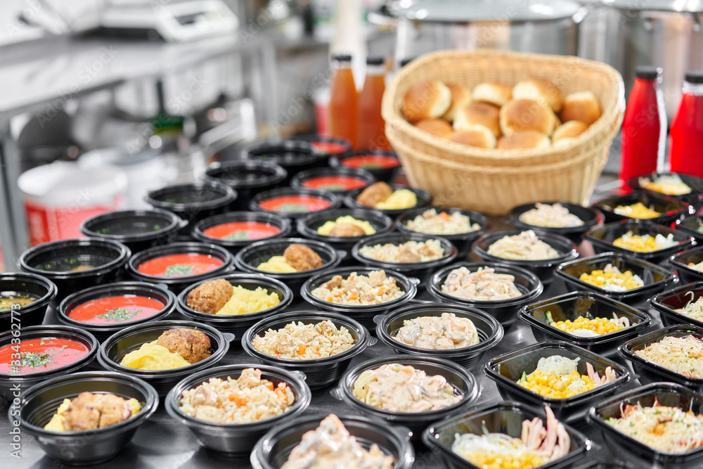 Food delivery. Different in plastic disposable lunch box with healthy natural food. Chicken broth, mashed soup, mashed potatoes with cutlet, seafood pasta, salads, pilaf with a fresh bun. Food delivery. Different in plastic disposable lunch box with healthy natural food. Chicken broth, mashed soup, mashed potatoes with cutlet, seafood pasta, salads, pilaf with a fresh bun.