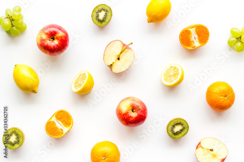 Fototapeta Naklejka Na Ścianę i Meble -  Colorful fruit pattern. Cut apple, kiwi, citrus on white background top-down