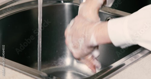 Closeup of unrecognizable woman washing hands throughly photo