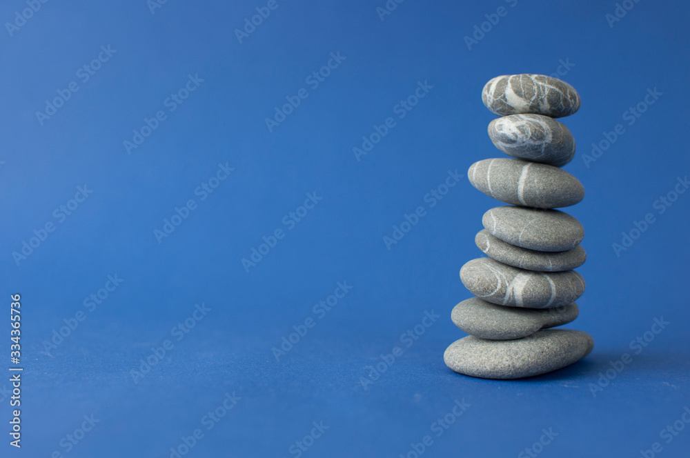Stack of stones on wooden table, space for text. Zen concept Stack of stones on wooden table, space for text. Zen concept