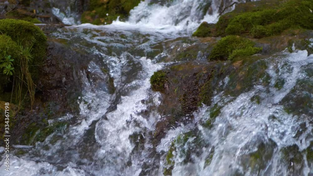Close-up waterfall, water falling and bubbling slow motion