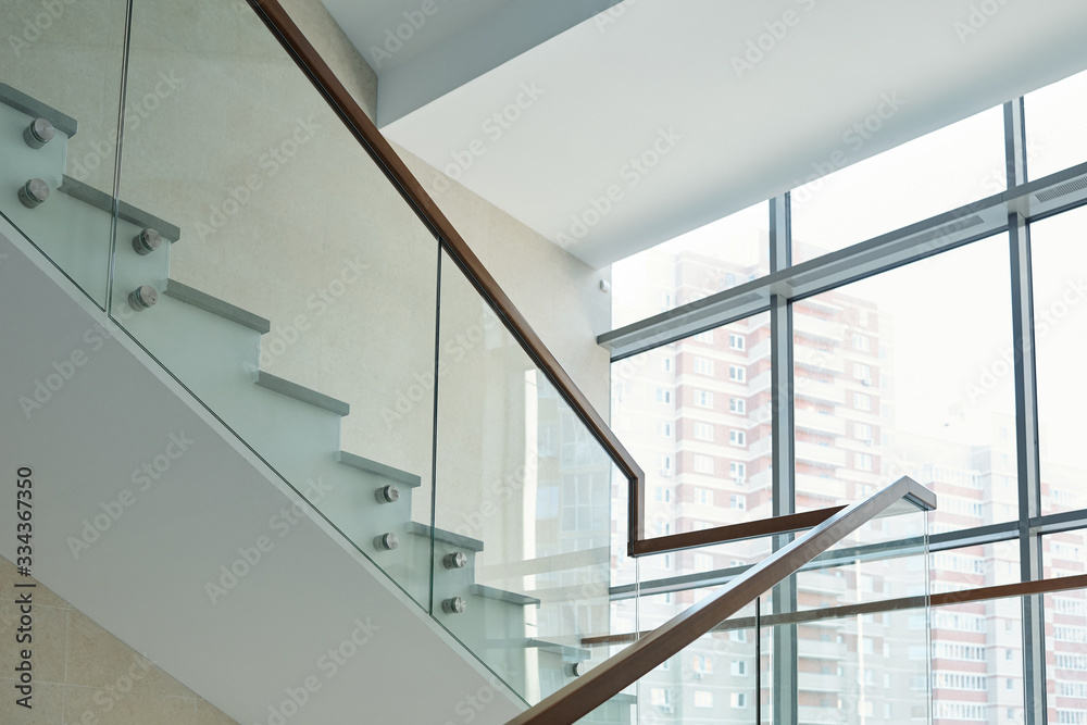 Part of staircase with railings and large window inside new business center Part of staircase with railings and large window inside new business center