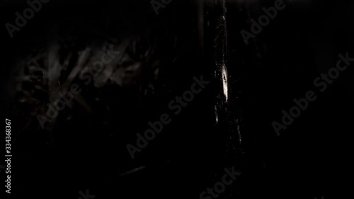 Texture of a shot into a wall, bulletproof vest from a firearm, through penetration of an obstacle by an incendiary projectile, the bullet breaks through the barrier in slow motion