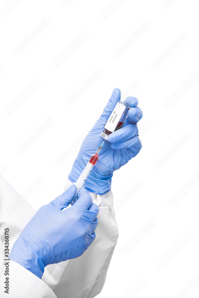 Gloved virologist taking anti covid19 vaccine from small bottle into syringe Gloved virologist taking anti covid19 vaccine from small bottle into syringe