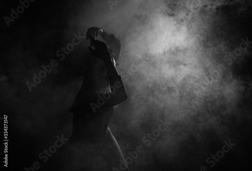 Female silhouette in shadow and smoke